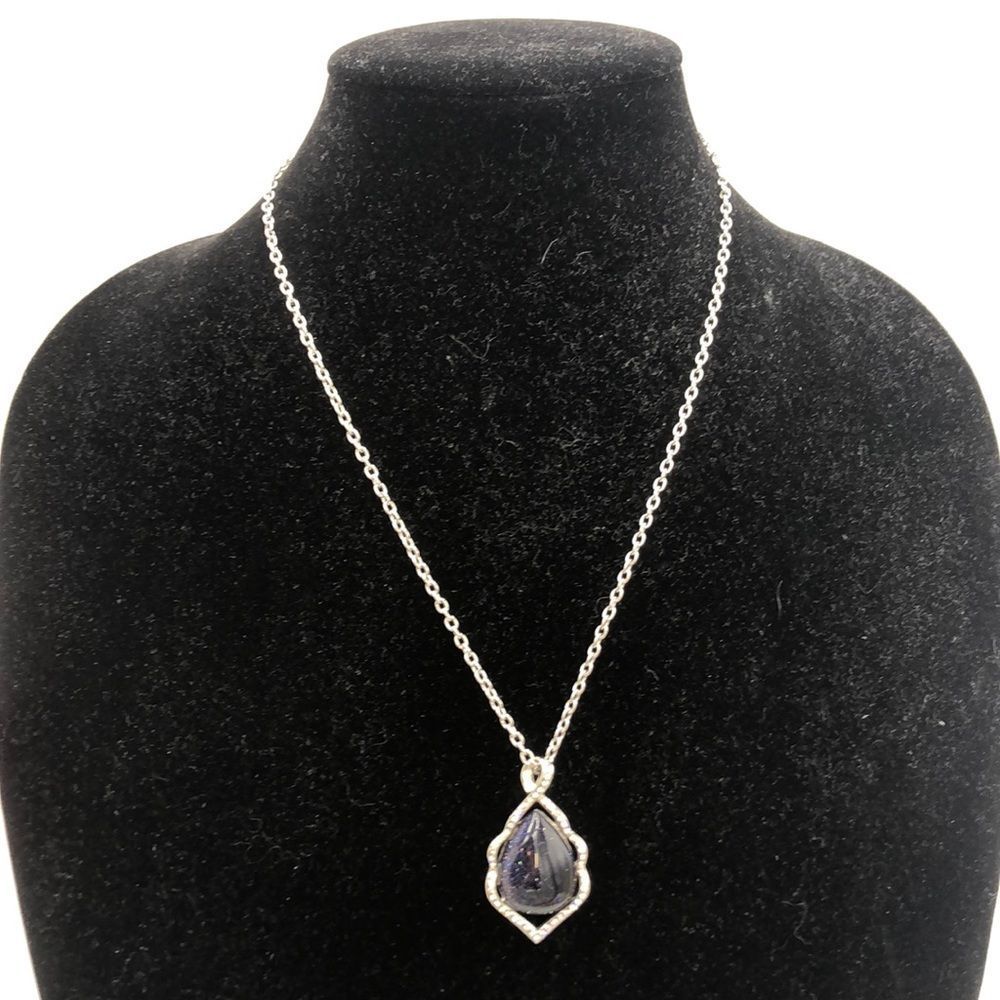 Lovely silver necklace w/purple stone surrounded with clear crystals. 10” chain